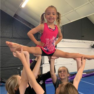 Young girl taking part in a stunt enjoying cheer for fum