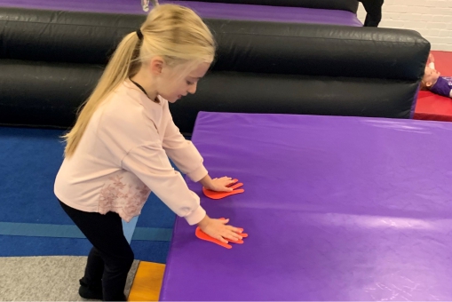 Toddler attempting a forward roll
